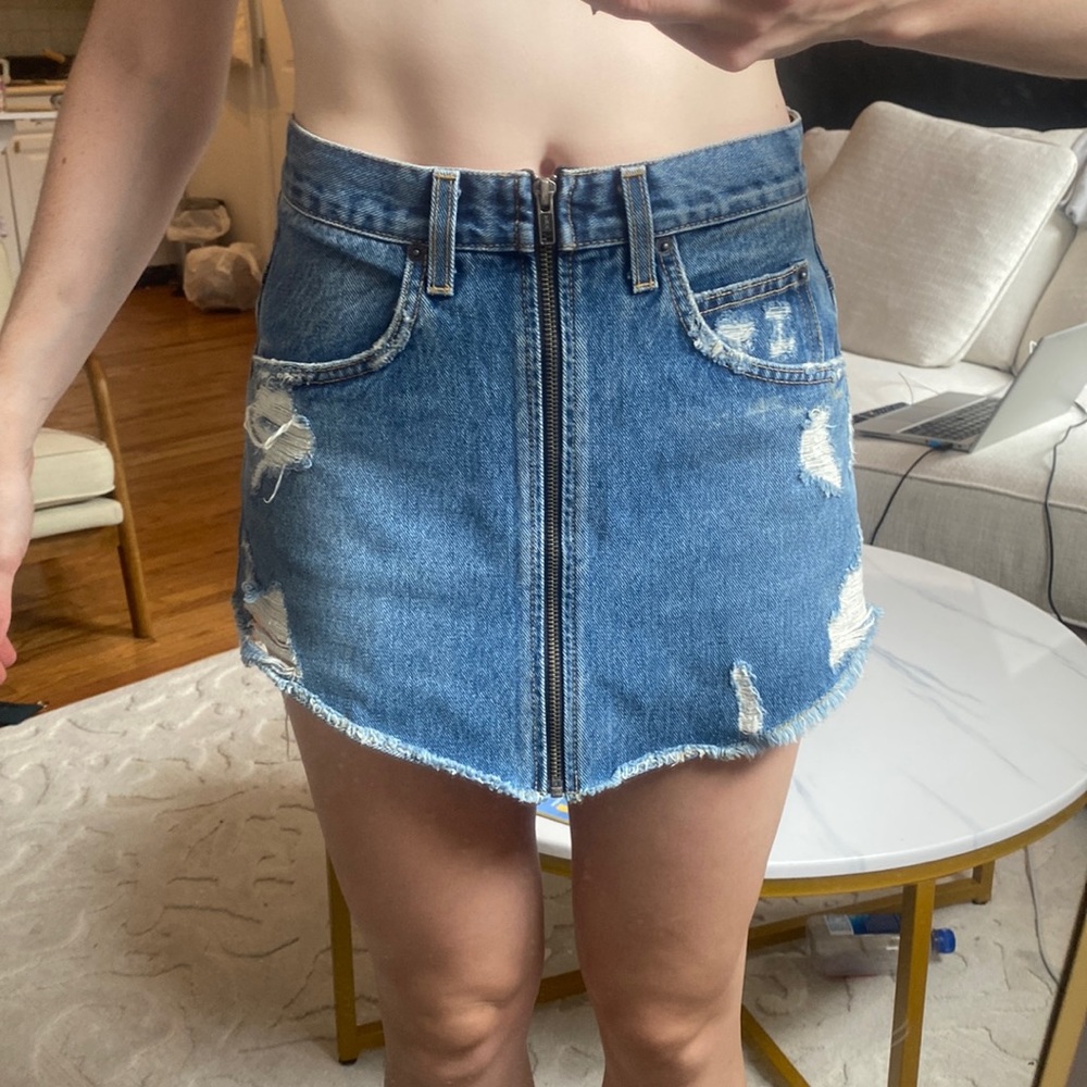 Carmar mini skirt angled cut with zipper. Ripped denim.
